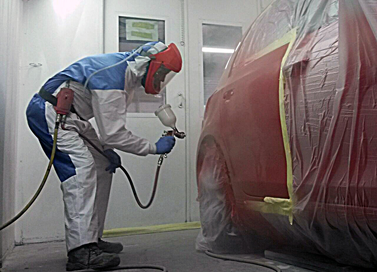 We are set up with a professional air-sealed respraying room Photo of car respray in action